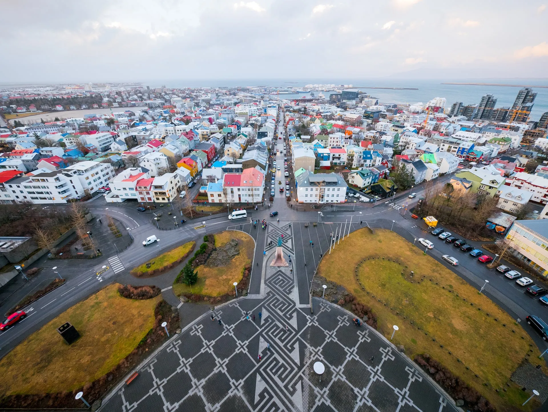 The view from Hallgrímskirkja tower down Skólavörðustígur over Reykjavík's colourful rooftops to the bay and mountains beyond