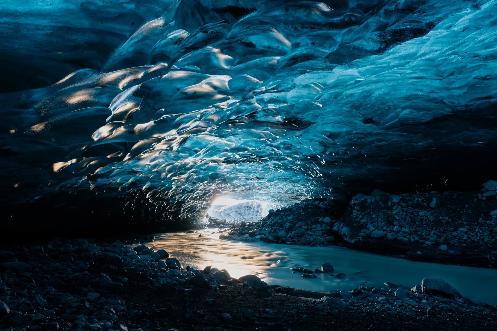 The glowing blue interior of a natural ice cave inside a Vatnajökull glacier in winter