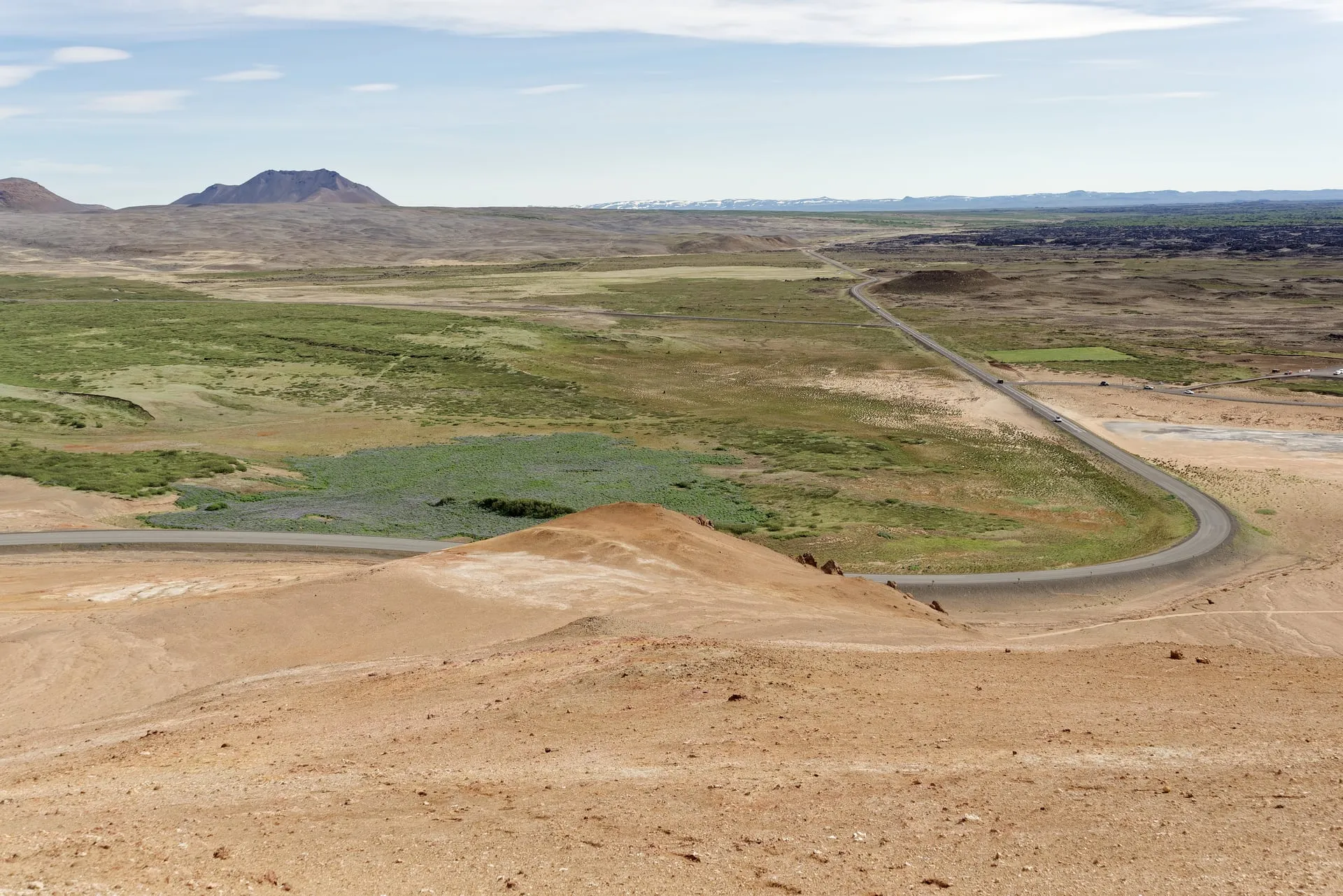 Iceland's Route 1 Ring Road sweeping through the volcanic Mývatn landscape, seen from Námafjall mountain
