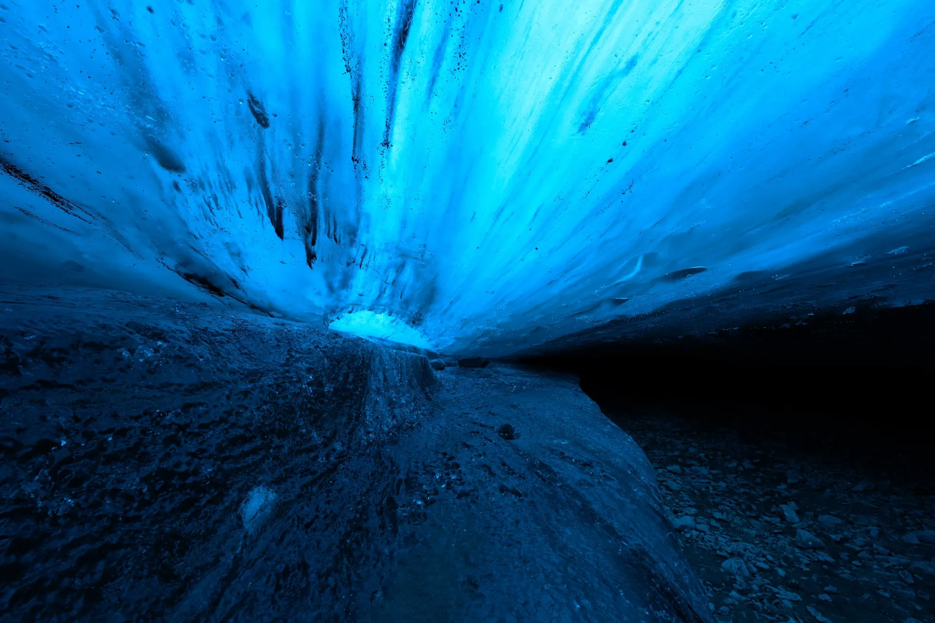 The blue ice ceiling of a natural glacier ice cave inside Vatnajökull, a winter-only sight in Iceland