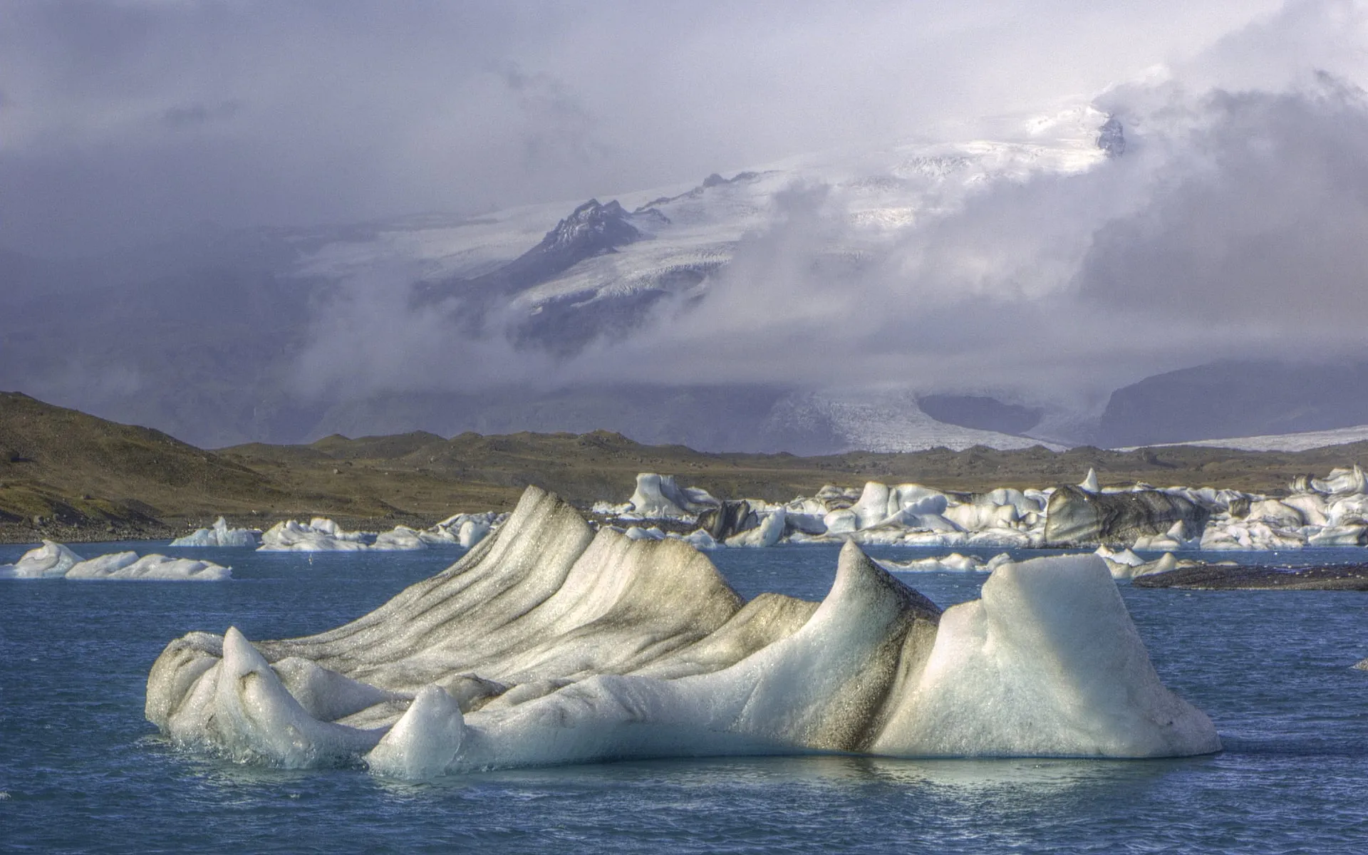 Icebergs drifting across Jökulsárlón glacier lagoon in Southeast Iceland