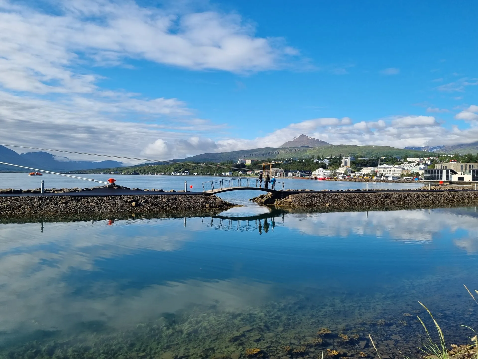 The harbour town of Akureyri in North Iceland with snow-capped mountains across the fjord