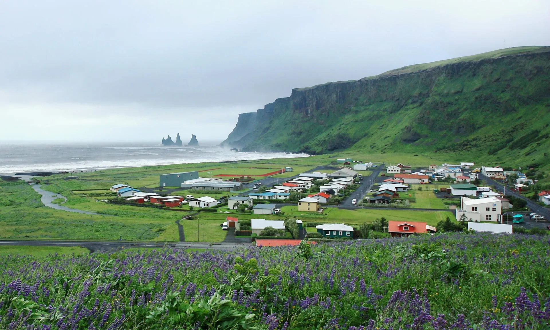 The village of Vík í Mýrdal with the Reynisdrangar sea stacks offshore